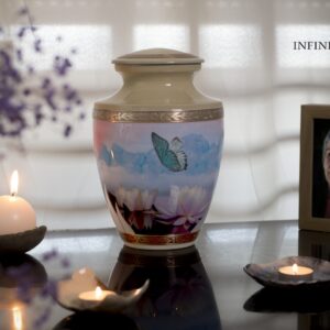 memorial table with a cremation urn of a butterfly with blue and yellow colors and a picture of my loved one