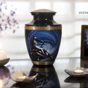 A black urn for ashes with a motorcycle driving to the sea with gold decorations